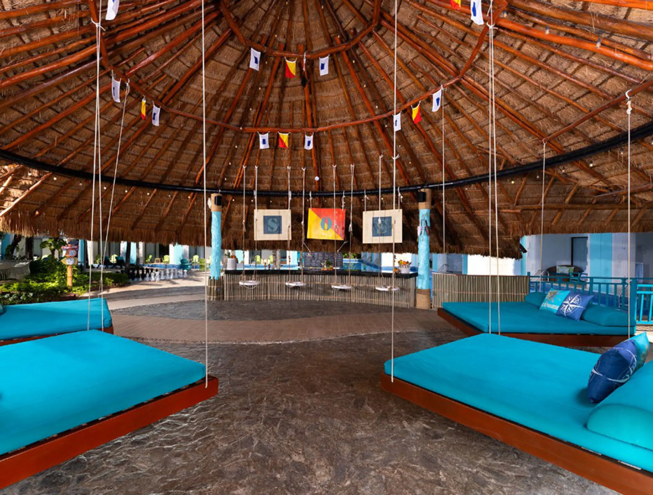 Turquoise daybeds under a palapa at Margaritaville Island Reserve Riviera Cancun