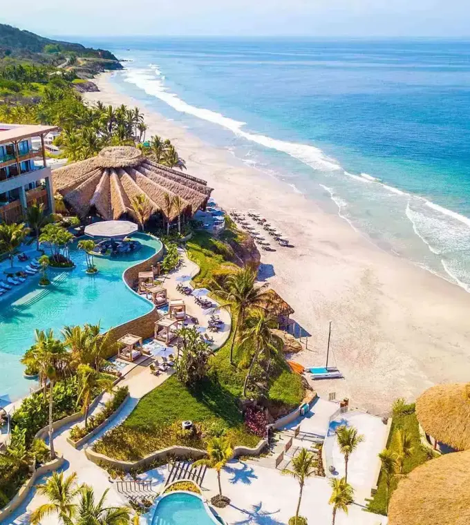 Aerial view of the pools and beachfront at Armony Marival, Puerto Vallarta