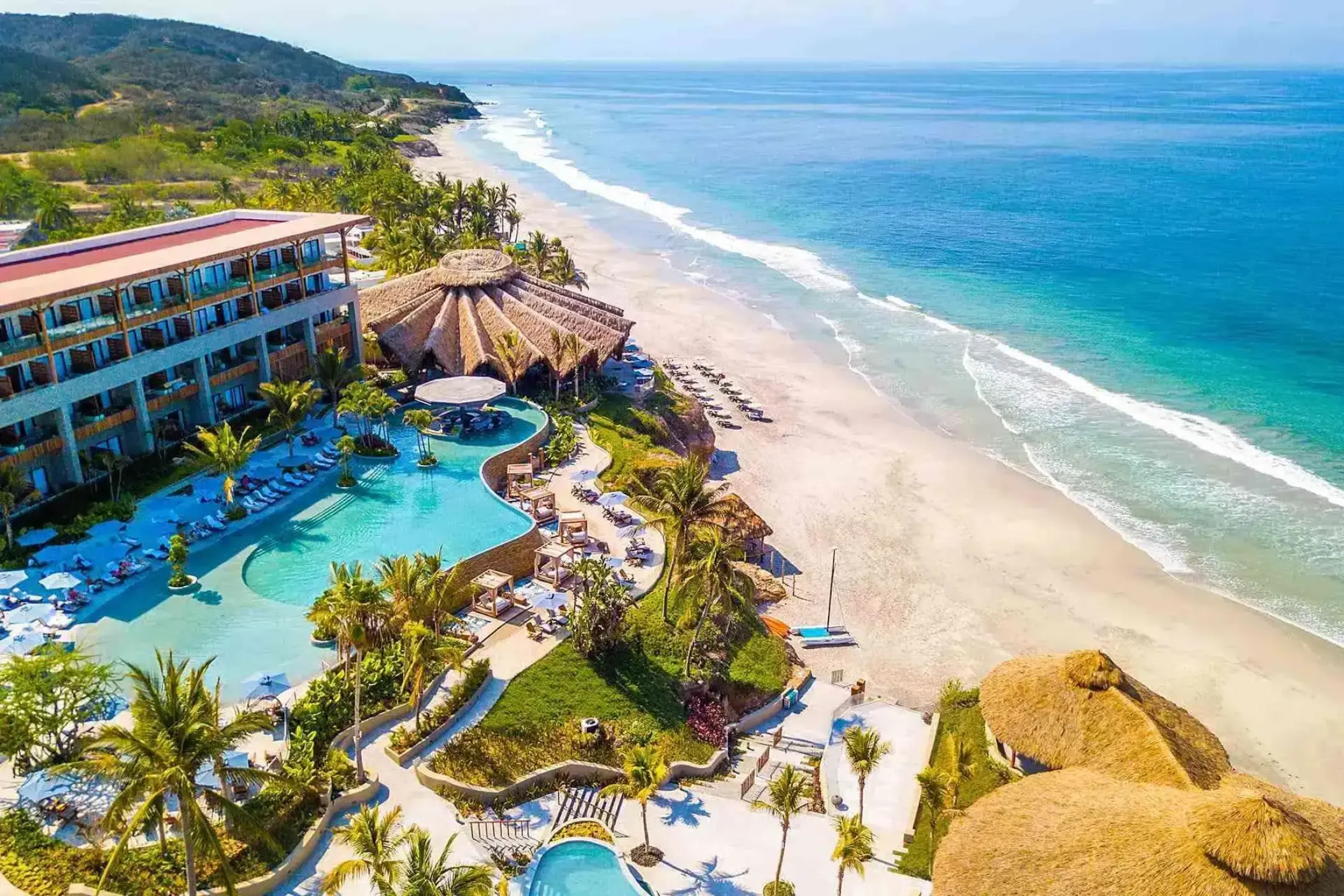 Aerial view of the pools and beachfront at Armony Marival, Puerto Vallarta