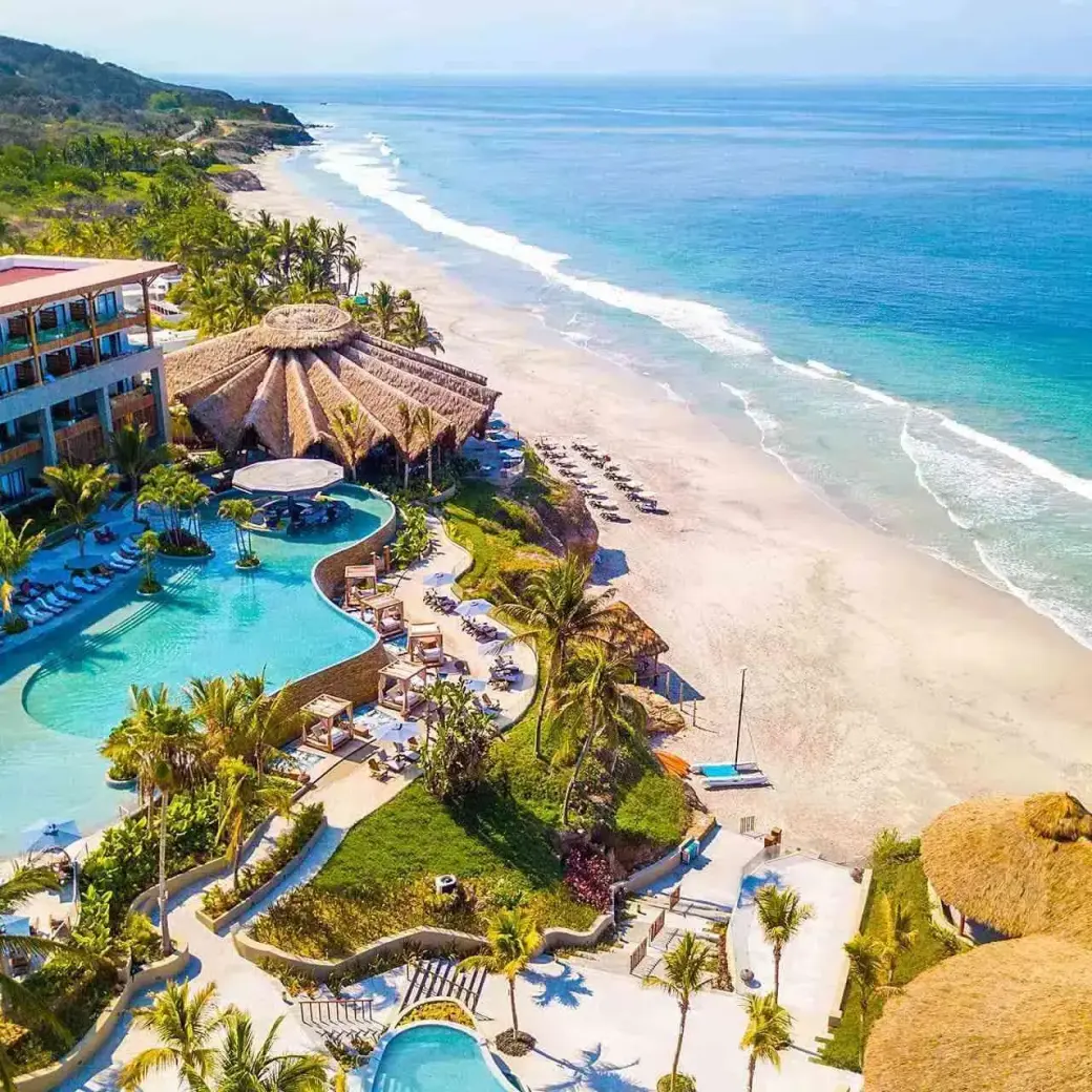 Aerial view of the pools and beachfront at Armony Marival, Puerto Vallarta