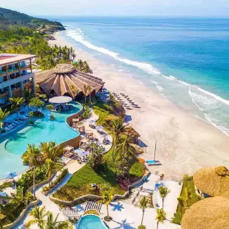 Aerial view of the beachfront pool and coast at Marival Armony, Puerto Vallarta