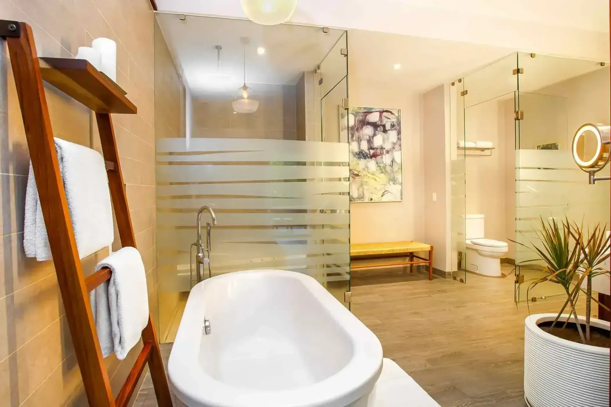 Modern suite bathroom with a freestanding soaking tub and glass shower at Marival Armony, Puerto Vallarta