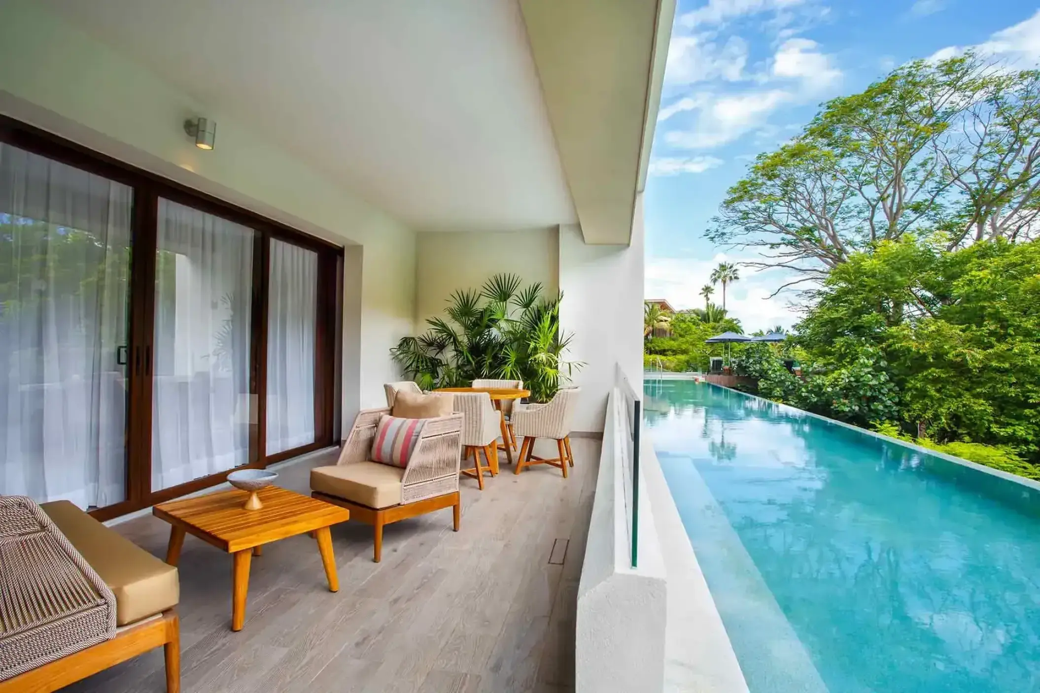 Marival Armony suite balcony with a swim-up pool and patio furniture, Puerto Vallarta