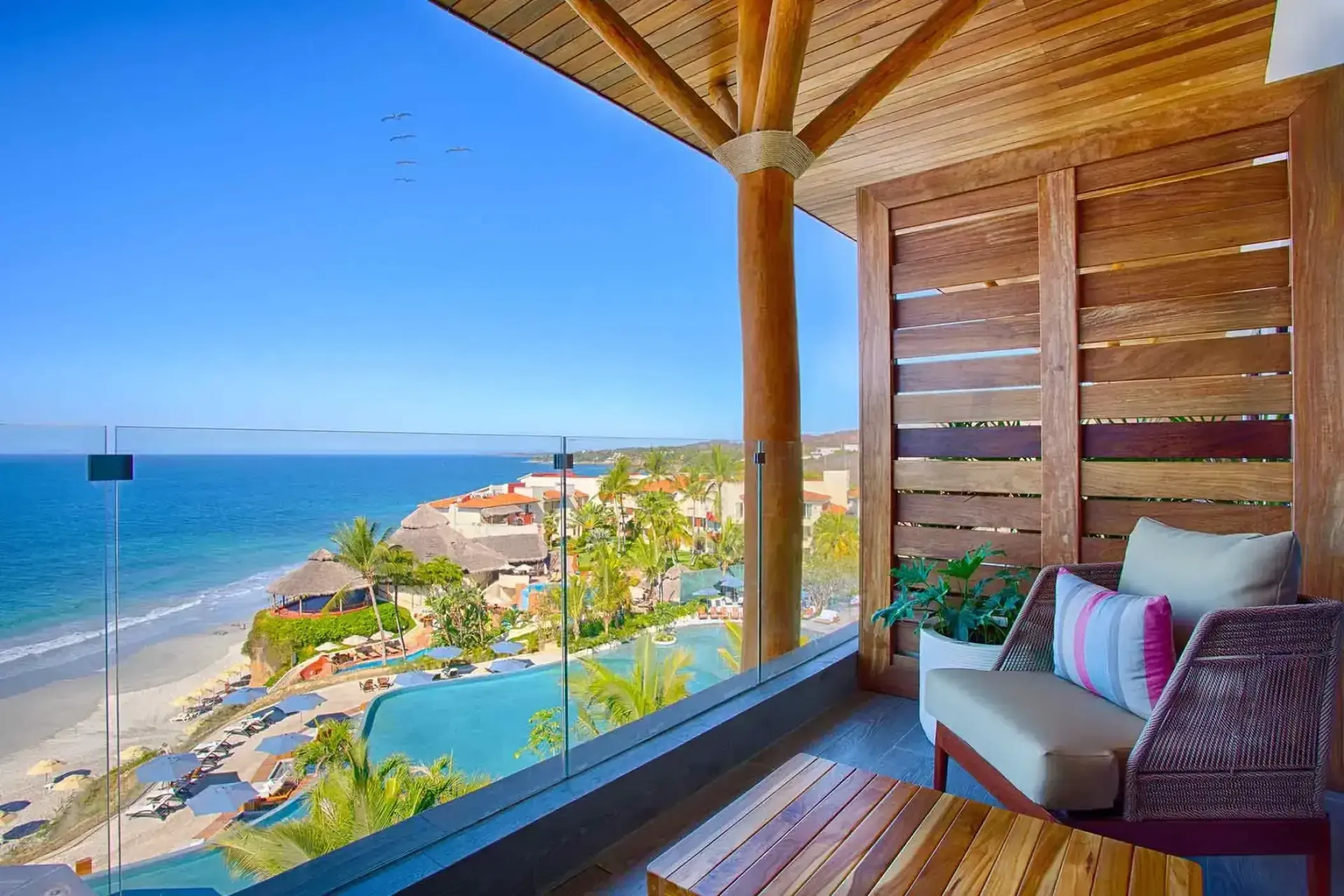 Private balcony with lounge chair and ocean views at Marival Armony, Puerto Vallarta