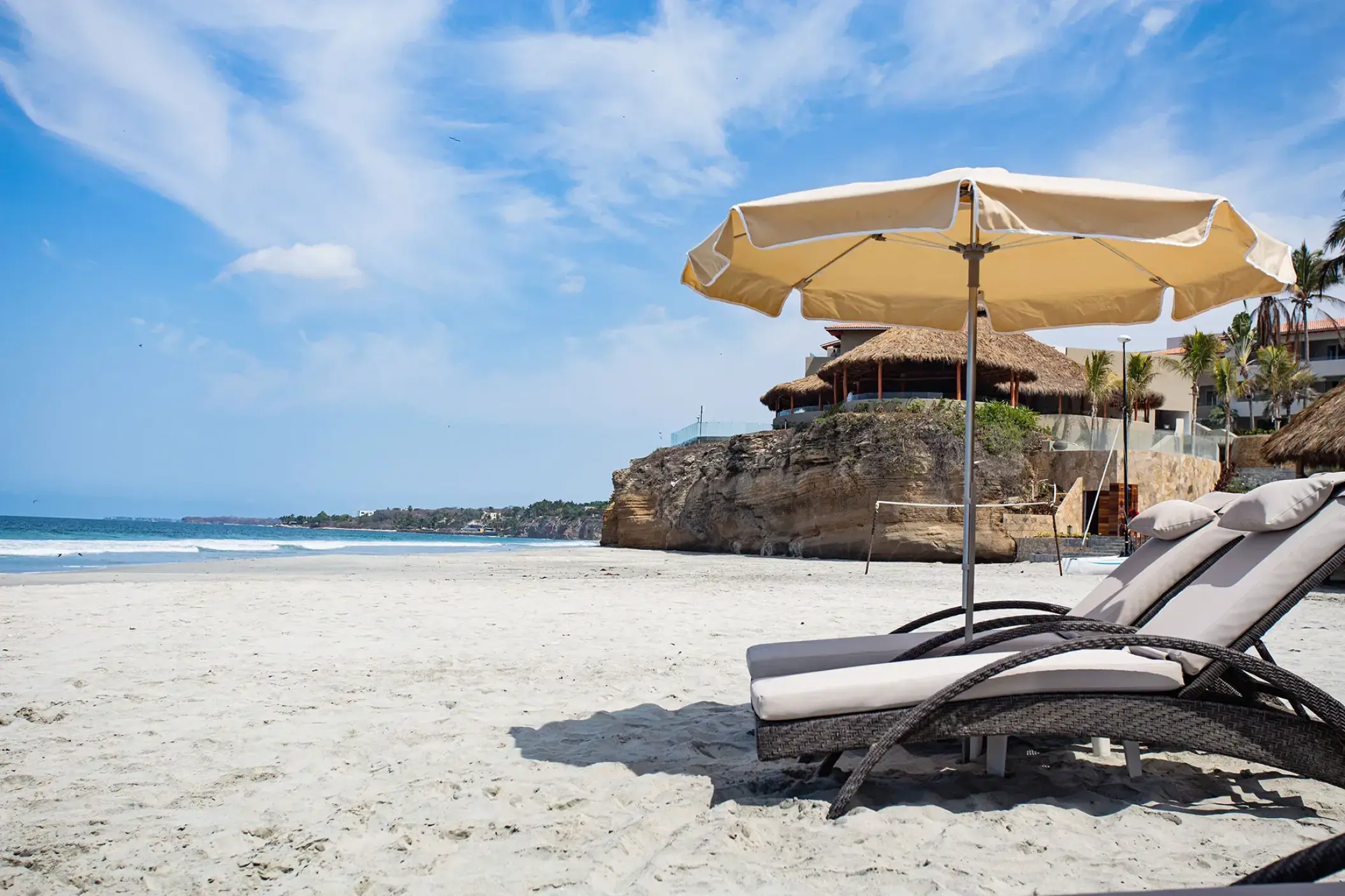 Lounge chairs and sun umbrella on the beach at Armony Marival, Puerto Vallarta