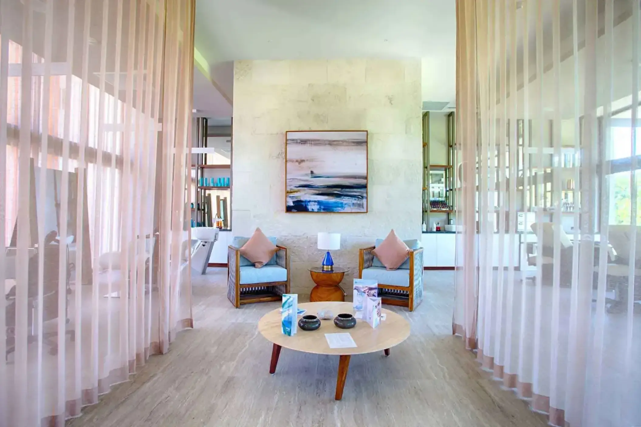 Modern beauty salon seating area with pink sheer curtains at Armony Marival, Puerto Vallarta
