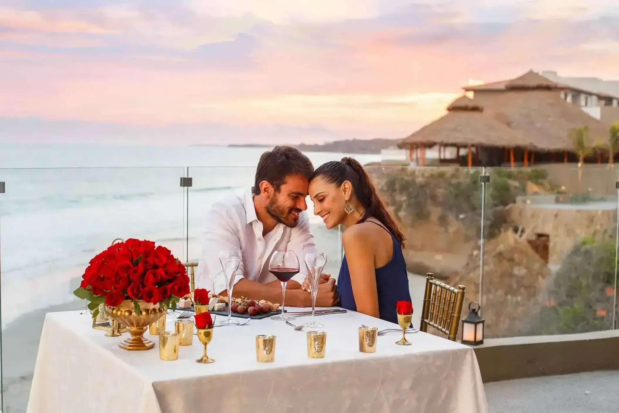 Couple enjoying a private sunset dinner overlooking the ocean at Armony Marival, Puerto Vallarta