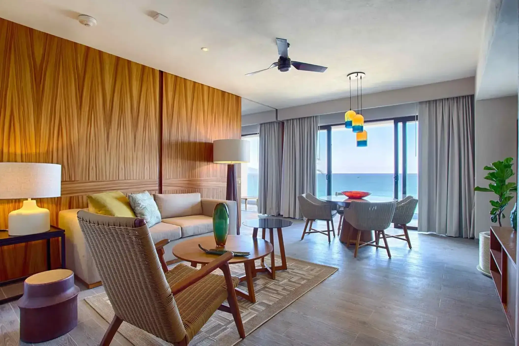 Marival Armony suite living area with wood paneled walls and ocean views, Puerto Vallarta