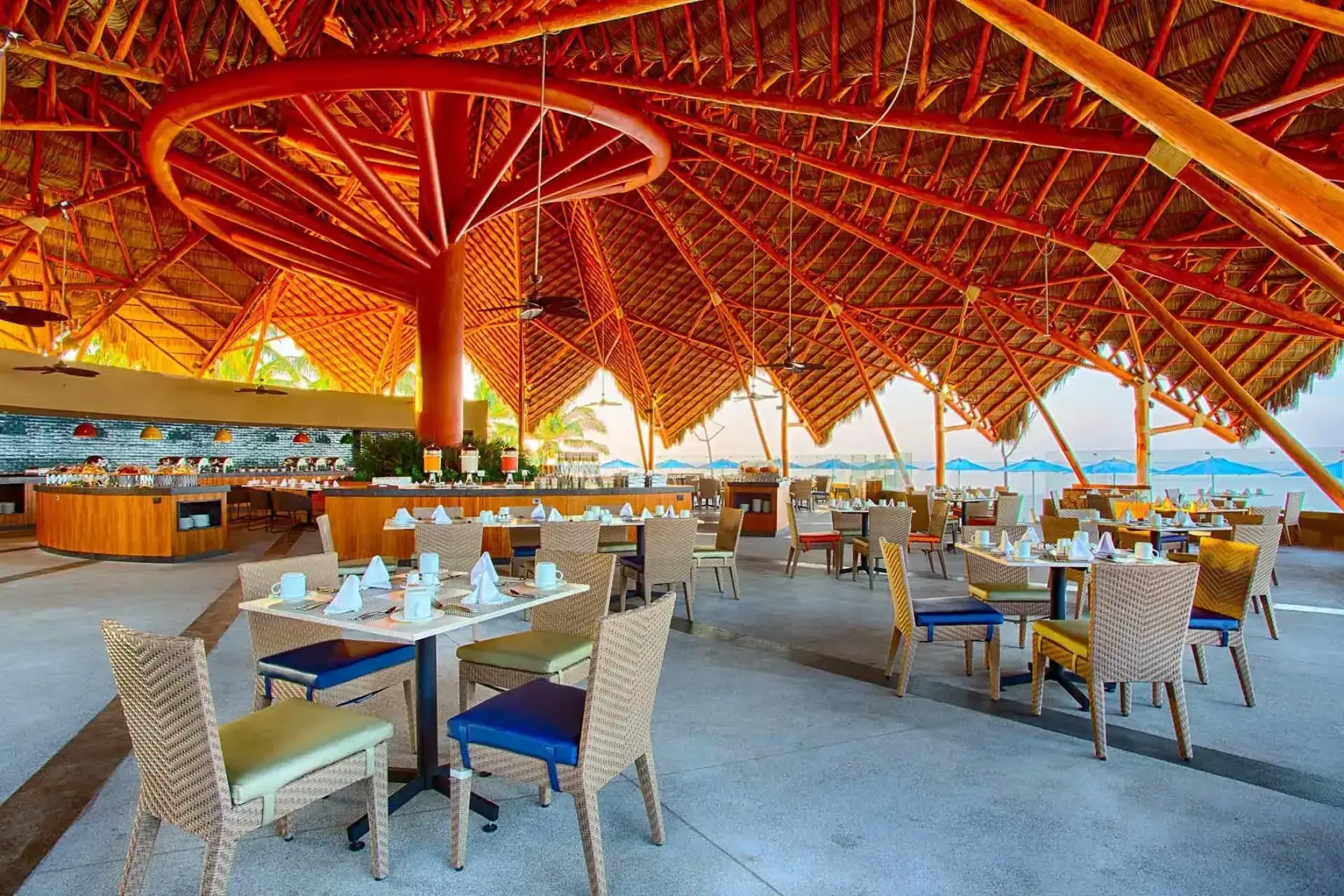 Open-air restaurant with a thatched palapa roof at Marival Armony, Puerto Vallarta