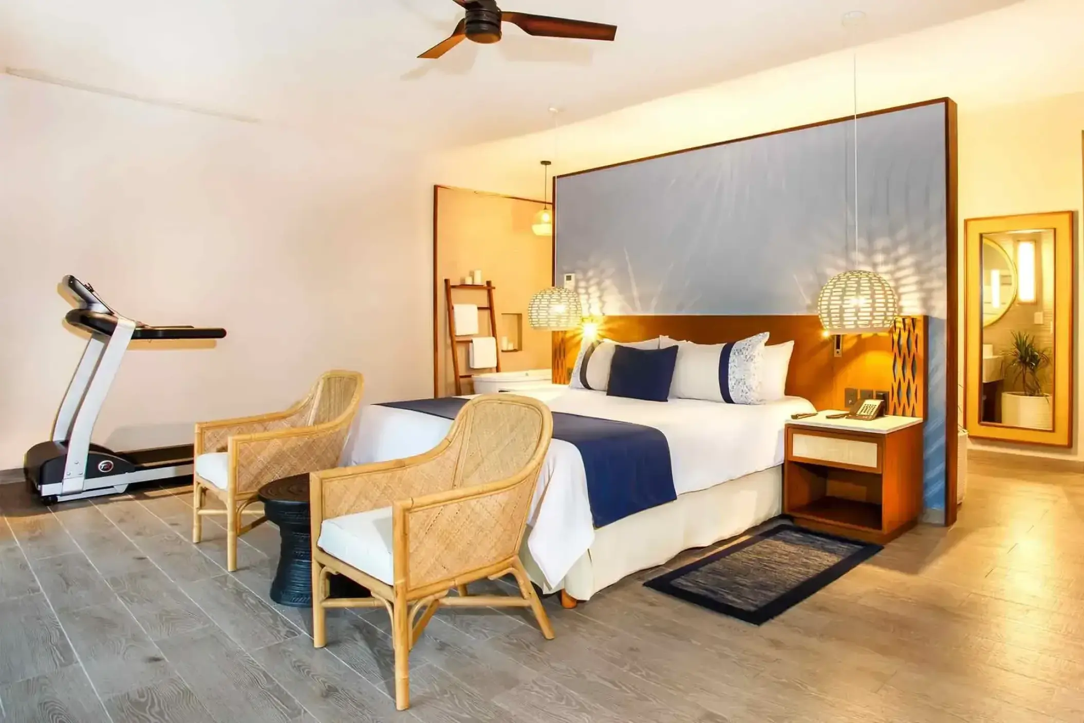 Modern suite with a treadmill and wicker seating at Marival Armony, Puerto Vallarta