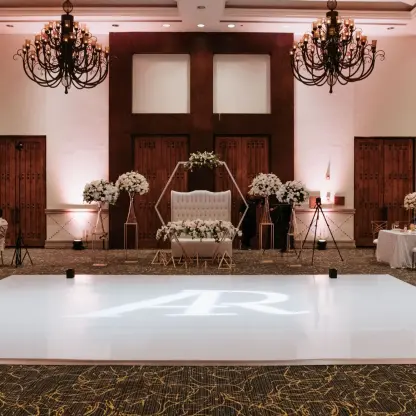 Indoor ballroom wedding reception with a monogrammed dance floor at Marquis Los Cabos, Cabo San Lucas
