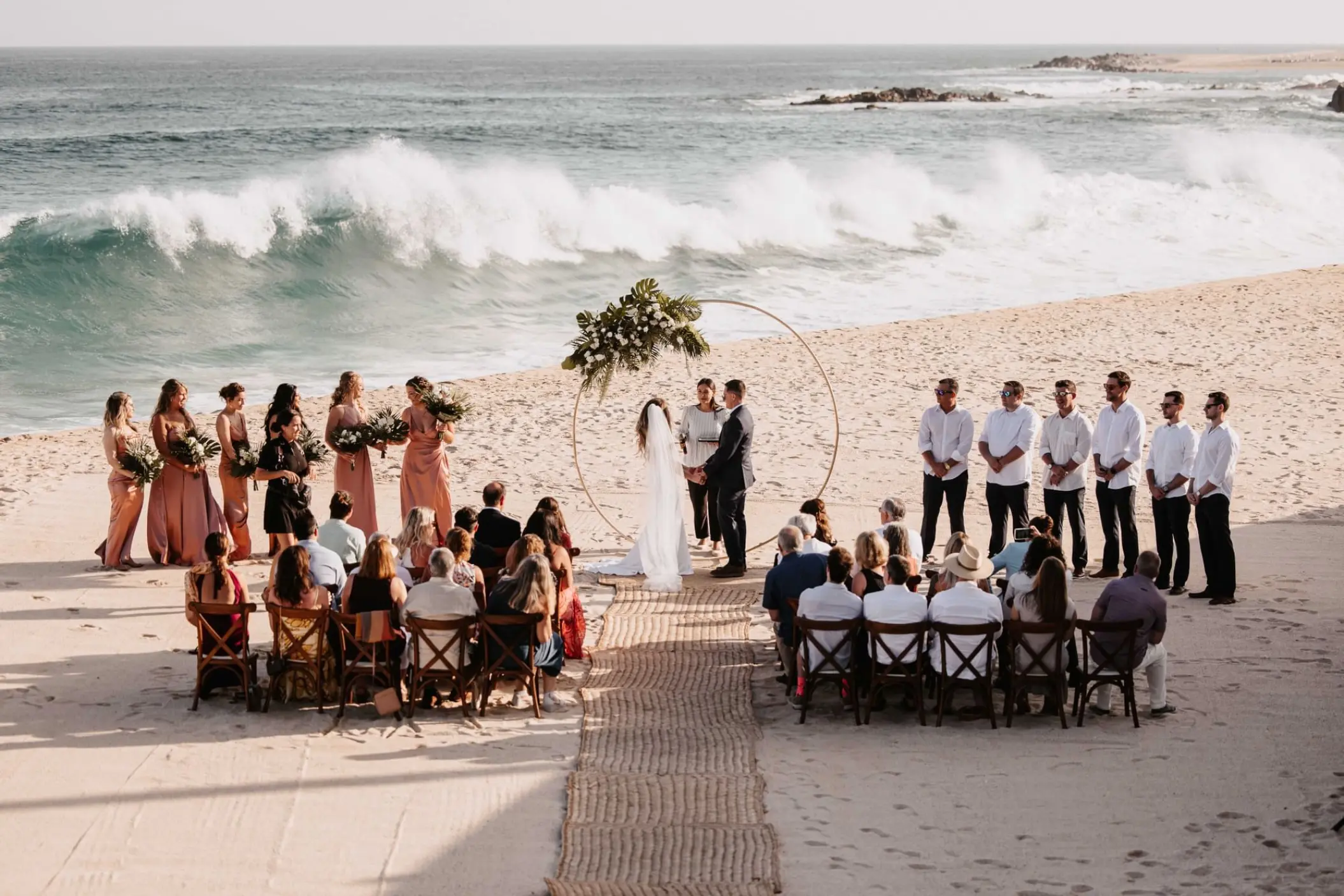 Beach wedding ceremony with crashing waves at Marquis Los Cabos, Cabo San Lucas