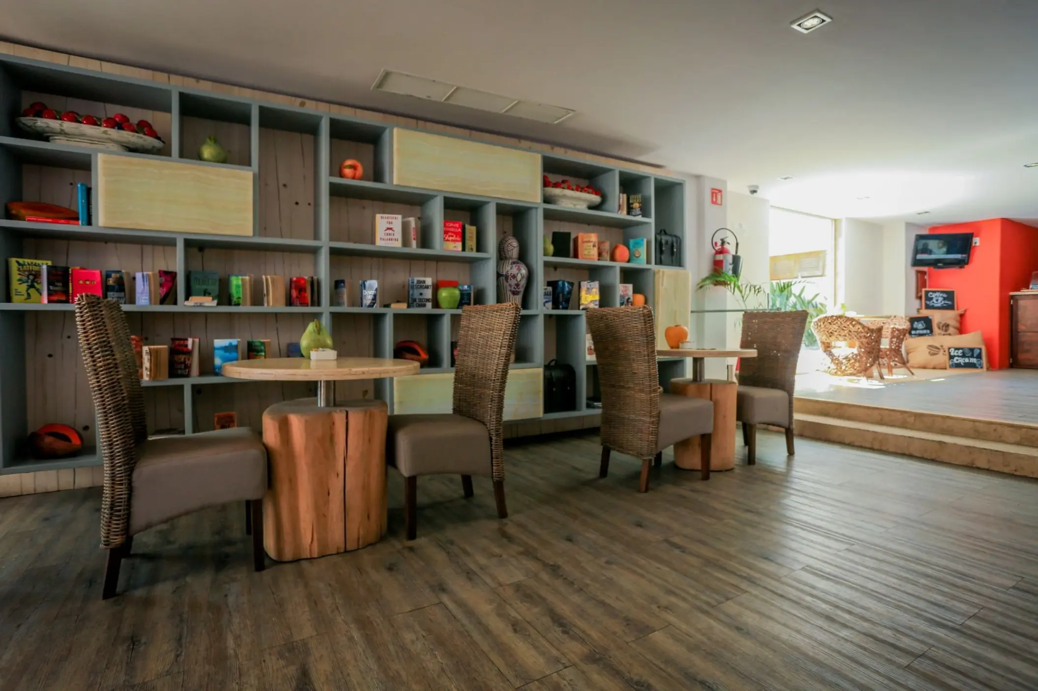 Cafe and lounge area with bookshelves at Marquis Los Cabos, Cabo San Lucas