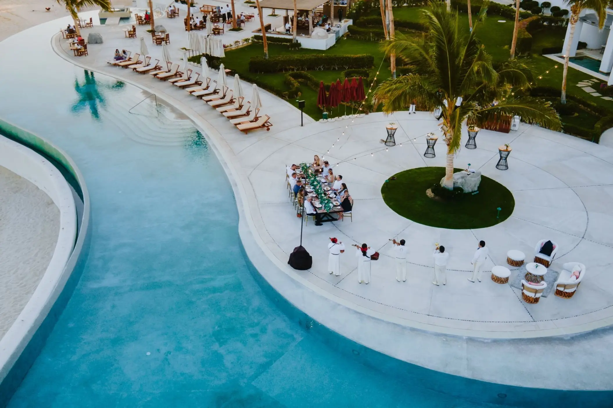 Aerial view of a wedding dinner reception on the pool terrace at Marquis Los Cabos, Cabo San Lucas