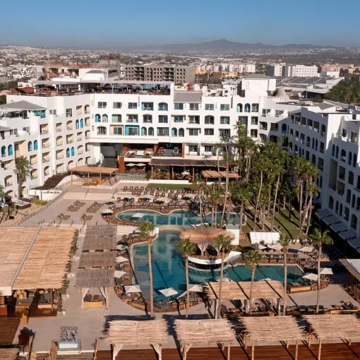 Aerial view of the pool area and white buildings at ME Cabo, Cabo San Lucas