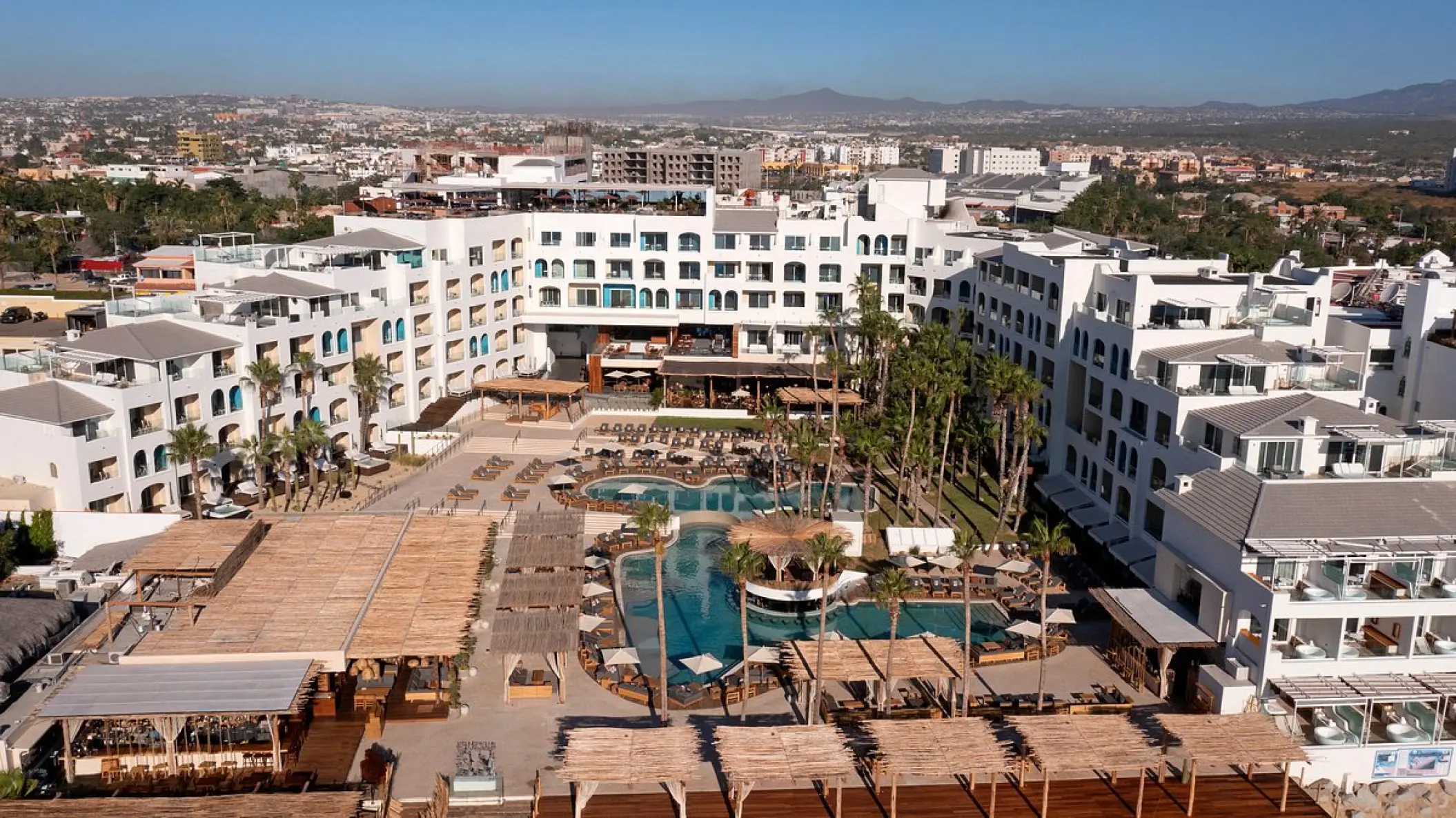 Aerial view of the pool area and white buildings at ME Cabo, Cabo San Lucas