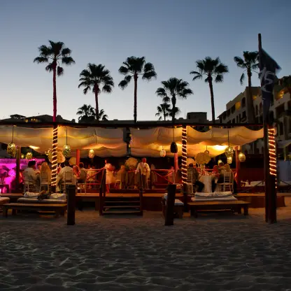 Evening wedding reception under a lighted canopy at ME Cabo, Cabo San Lucas