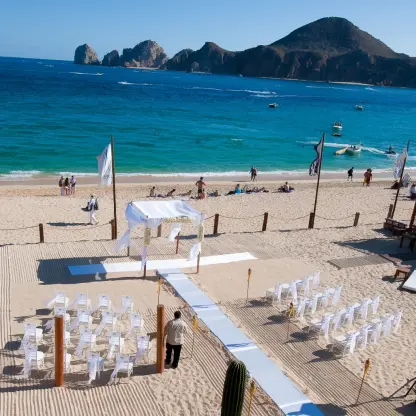 Beachfront wedding ceremony setup at ME Cabo, Cabo San Lucas