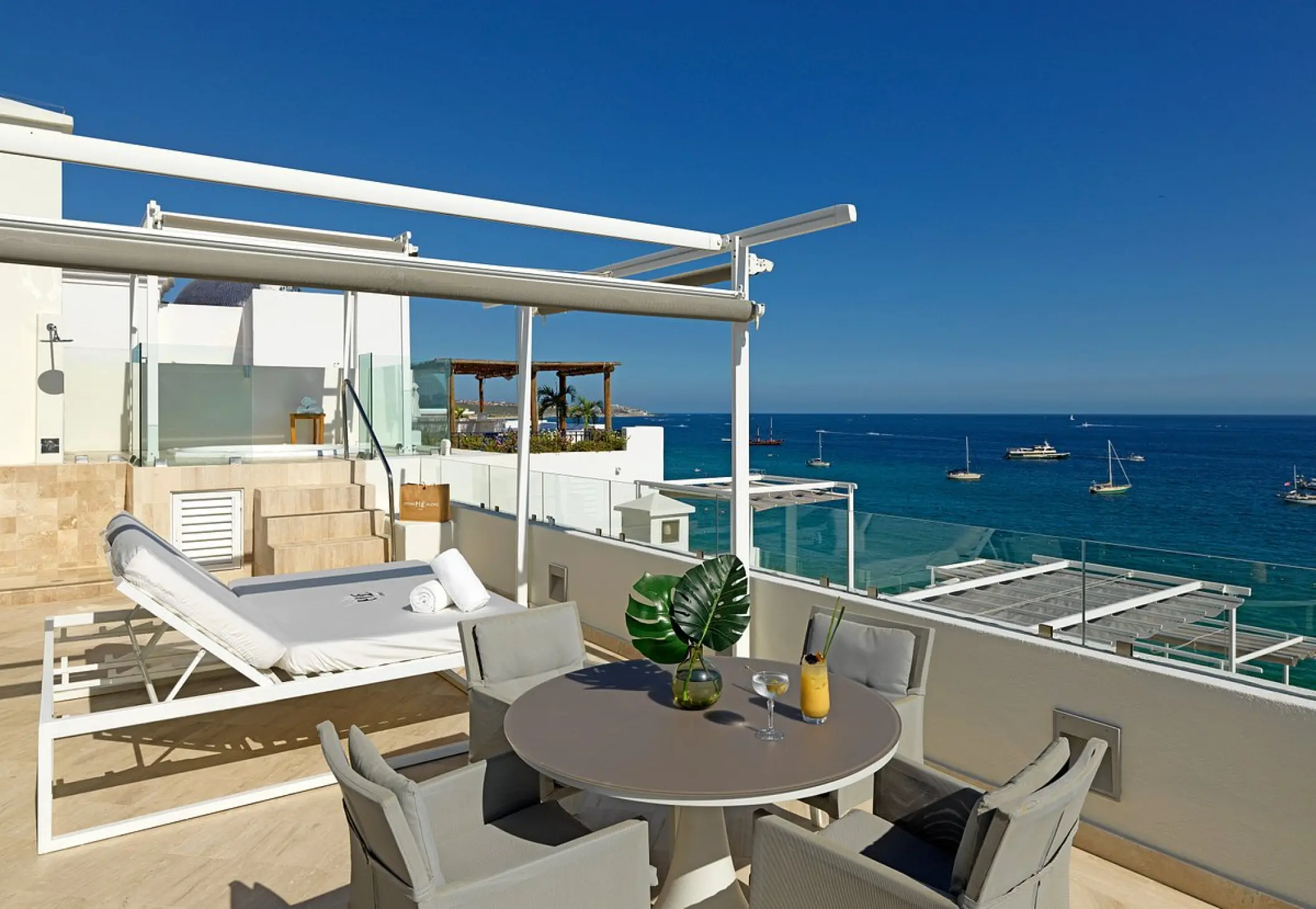Private terrace of the ME Suite with lounge bed and dining table at ME Cabo, Cabo San Lucas