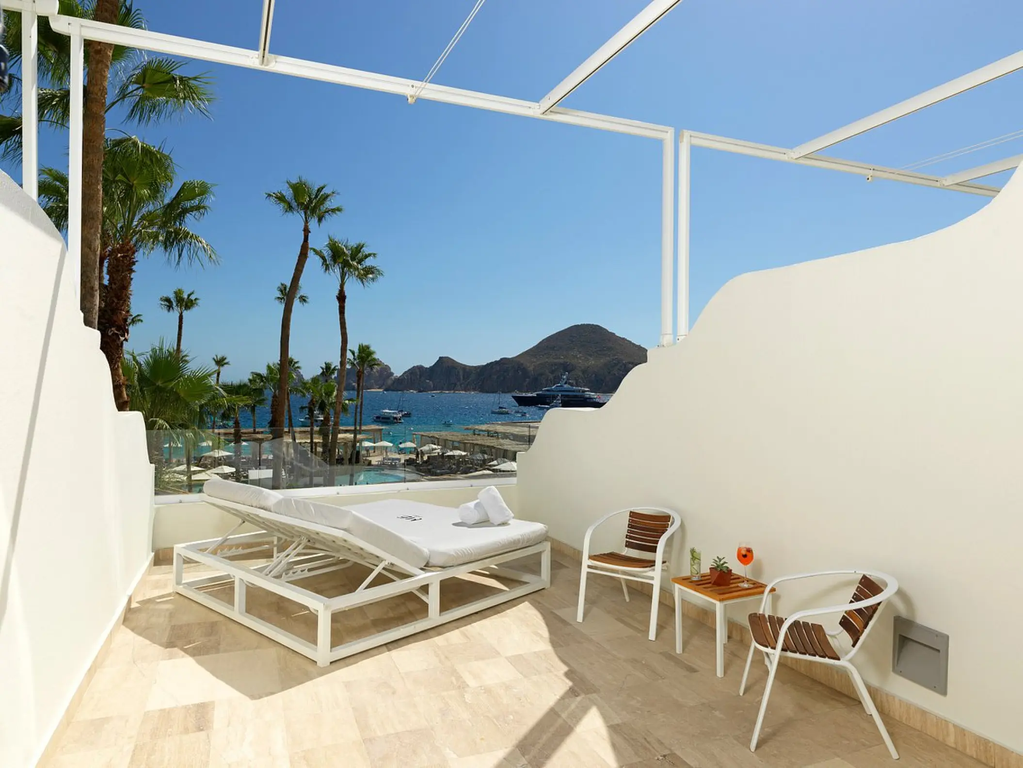 ME Cabo Extra ME Junior Suite balcony with daybed overlooking the ocean and Land's End, Cabo San Lucas