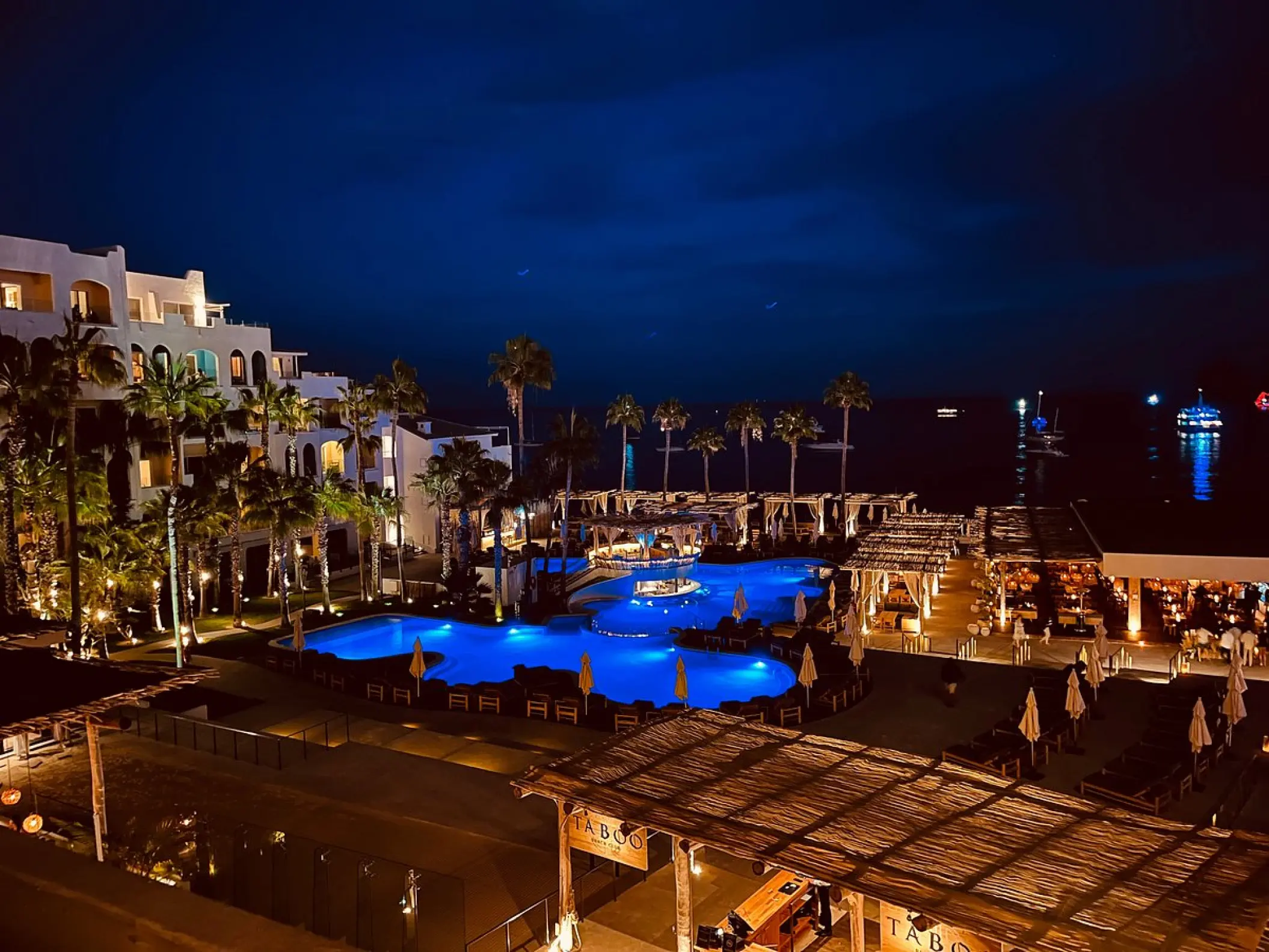 Illuminated pools and resort grounds at night at ME Cabo, Cabo San Lucas