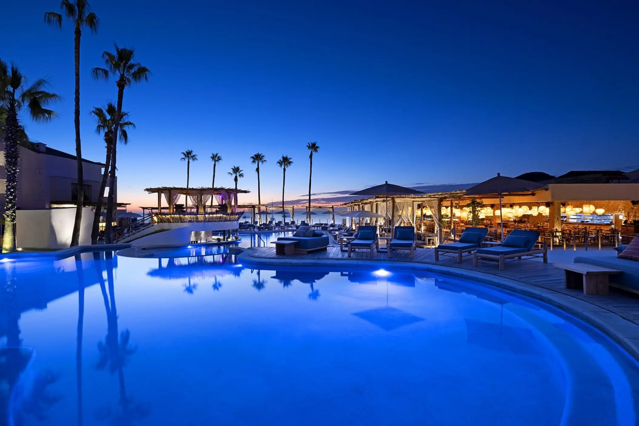Illuminated swimming pool at ME Cabo at night, Cabo San Lucas
