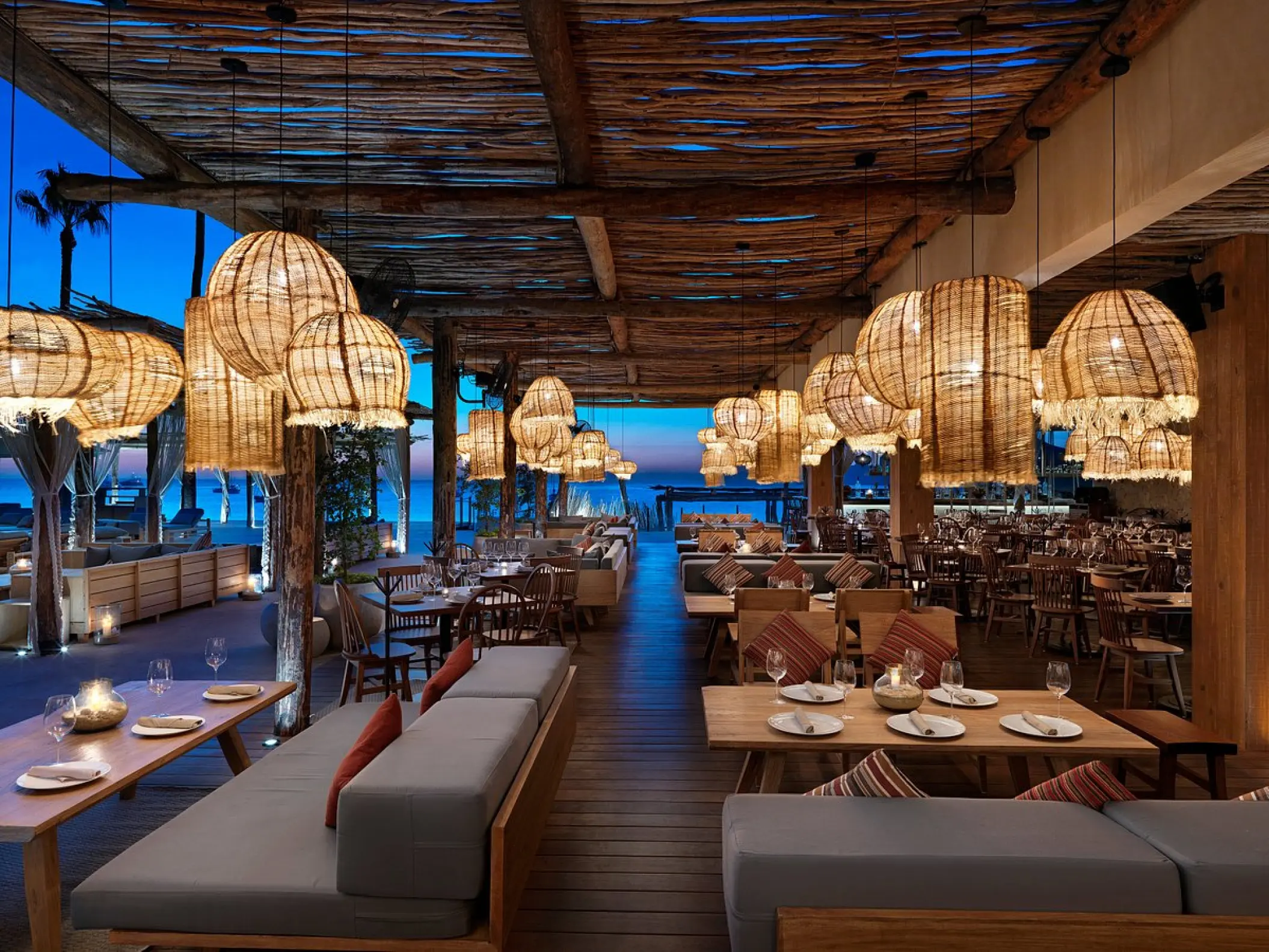 Taboo Beach Club with wicker lanterns at night at ME Cabo, Cabo San Lucas