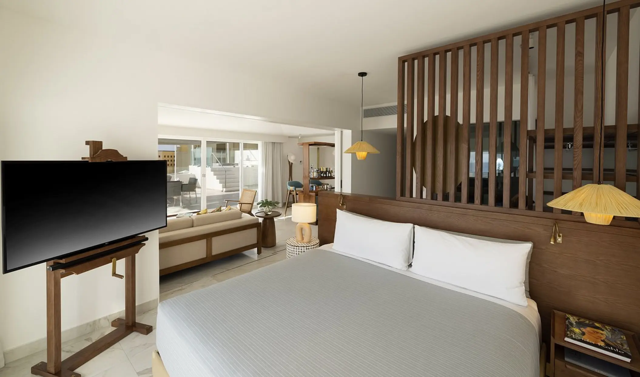 Modern suite with king bed and wooden room divider at ME Cabo, Cabo San Lucas