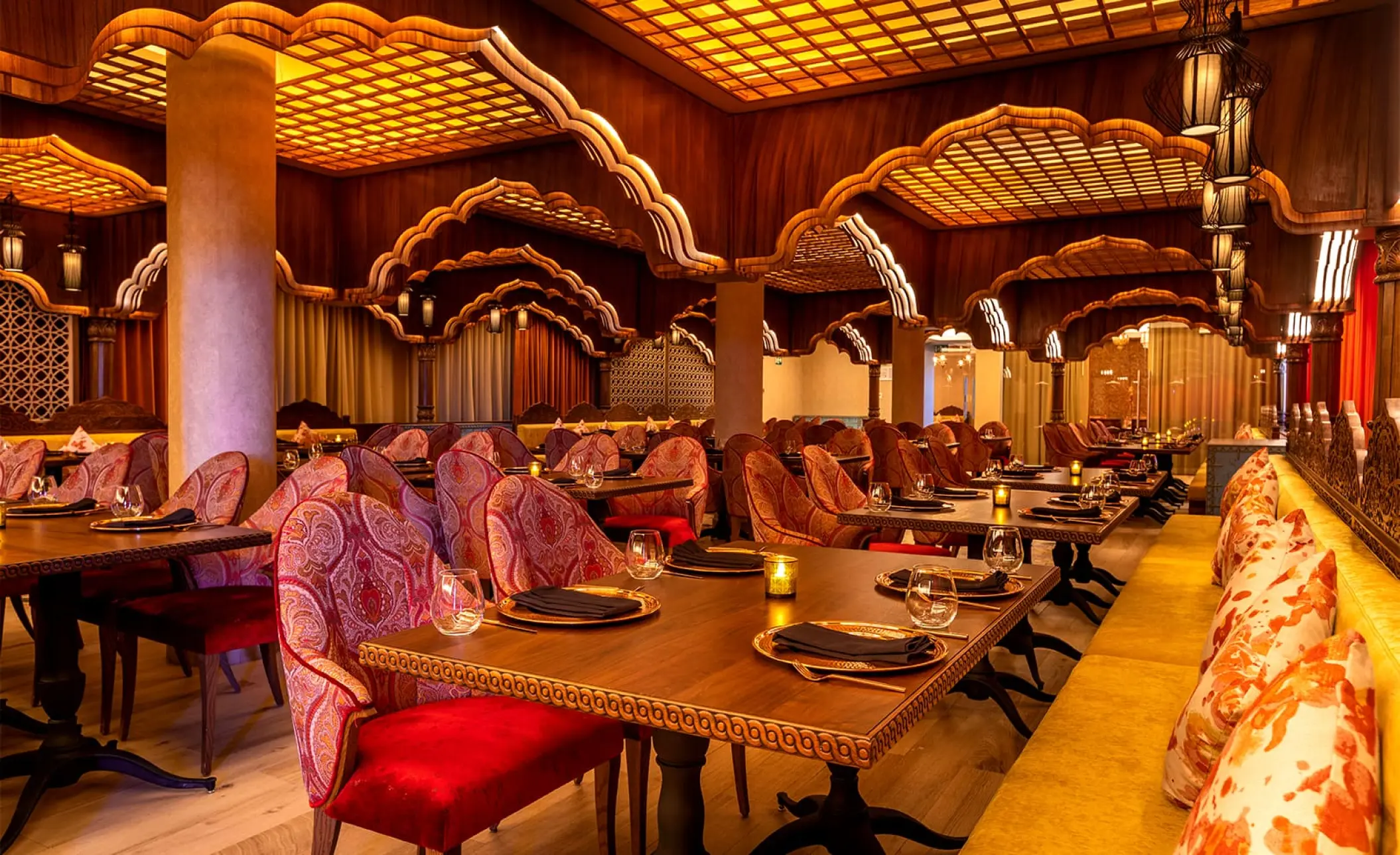 Agra restaurant interior with ornate archways and red seating at Moon Palace Cancun