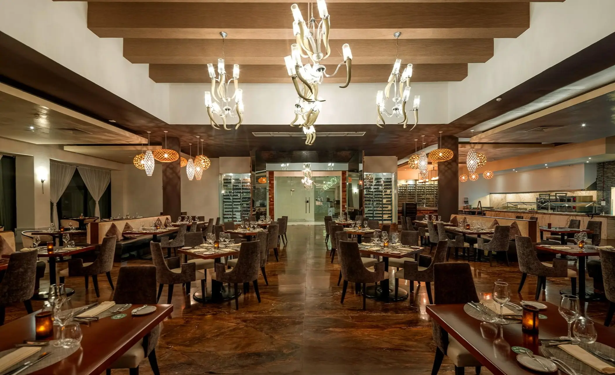 Arrecifes restaurant dining room with ornate chandeliers at Moon Palace Cancun