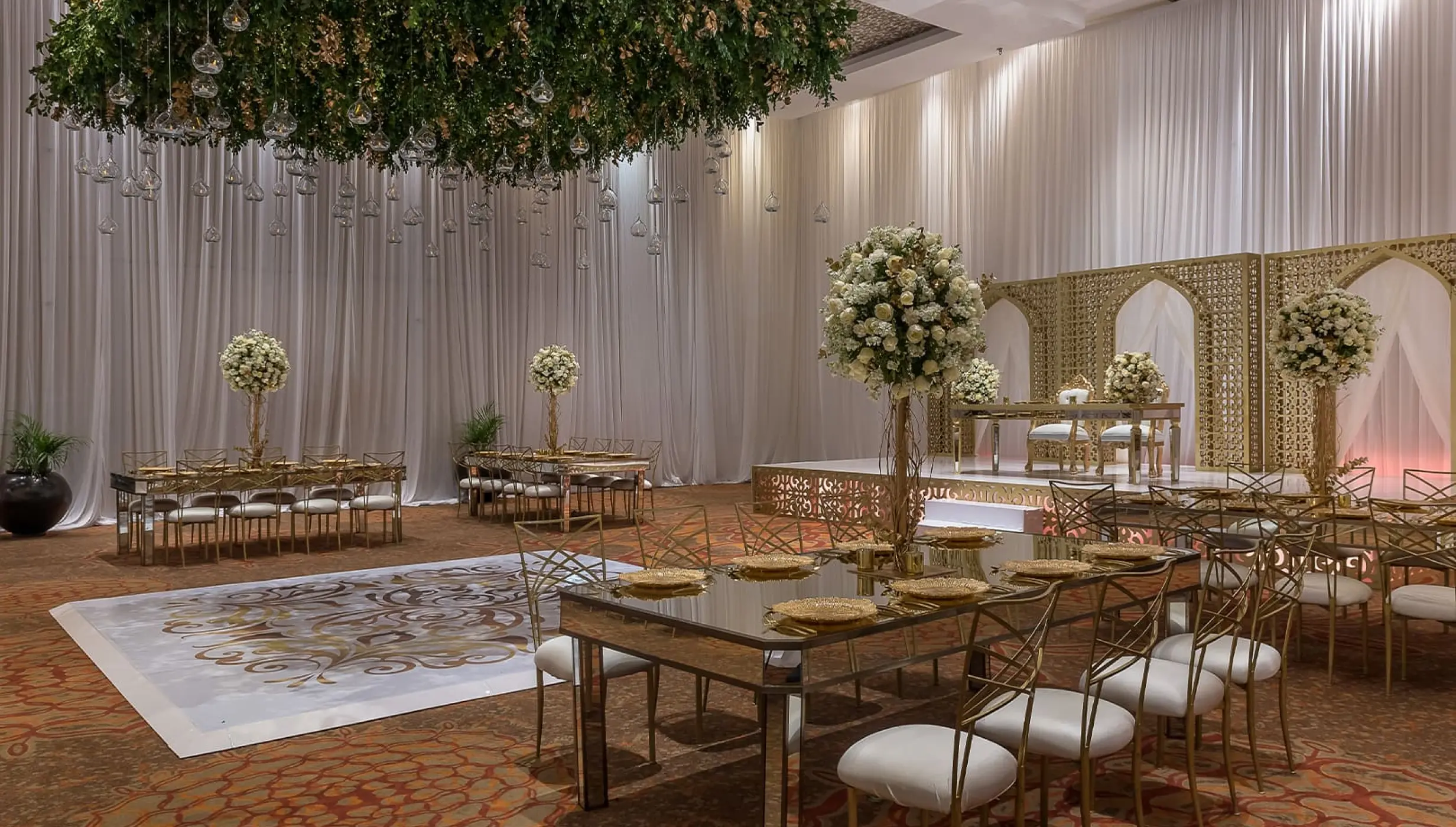 Indoor ballroom wedding reception with gold accents at Moon Palace Cancun