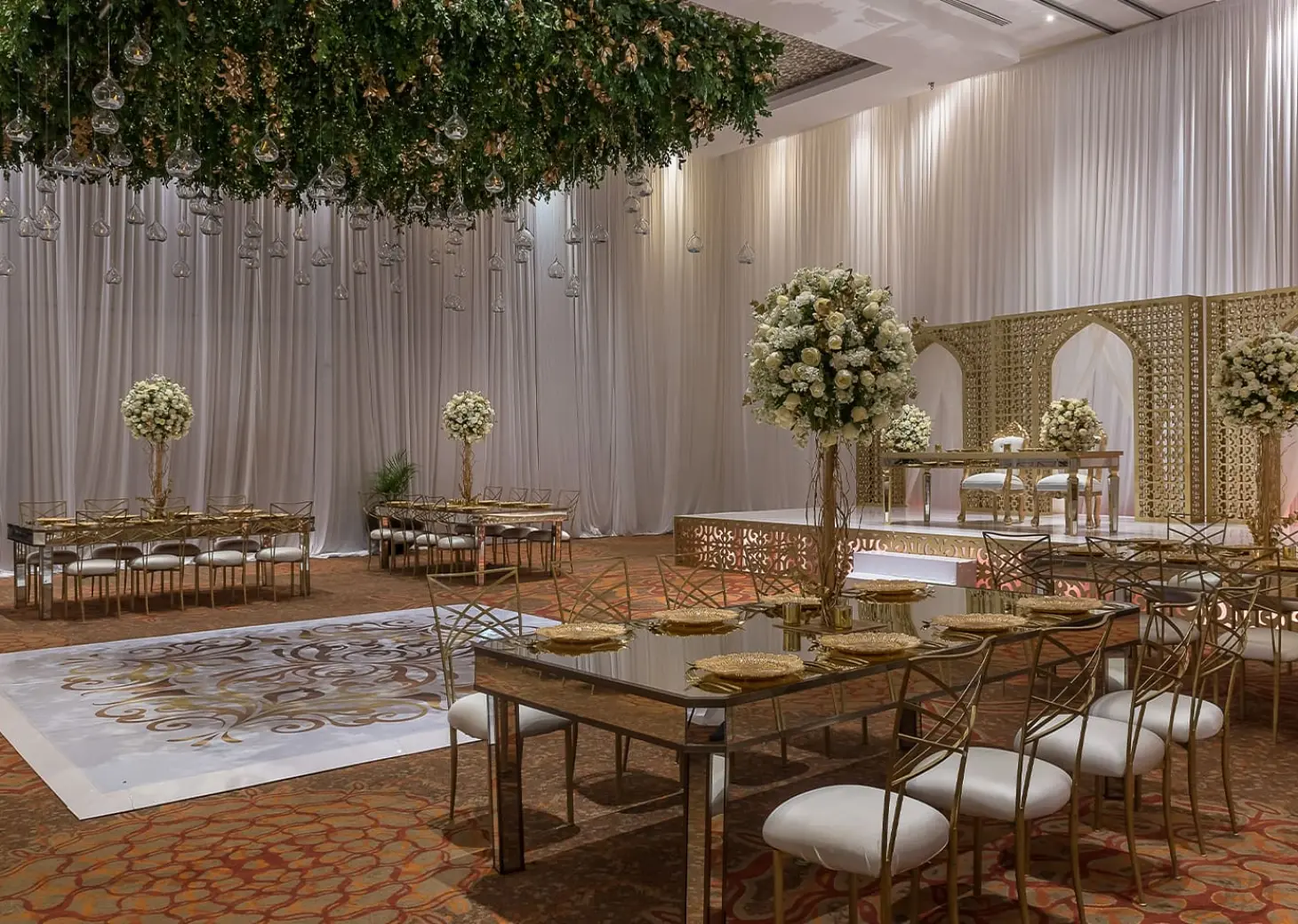 Indoor ballroom wedding reception with gold accents at Moon Palace Cancun