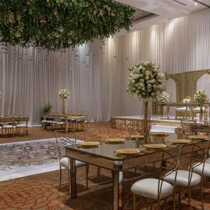Indoor ballroom wedding reception with gold accents at Moon Palace Cancun