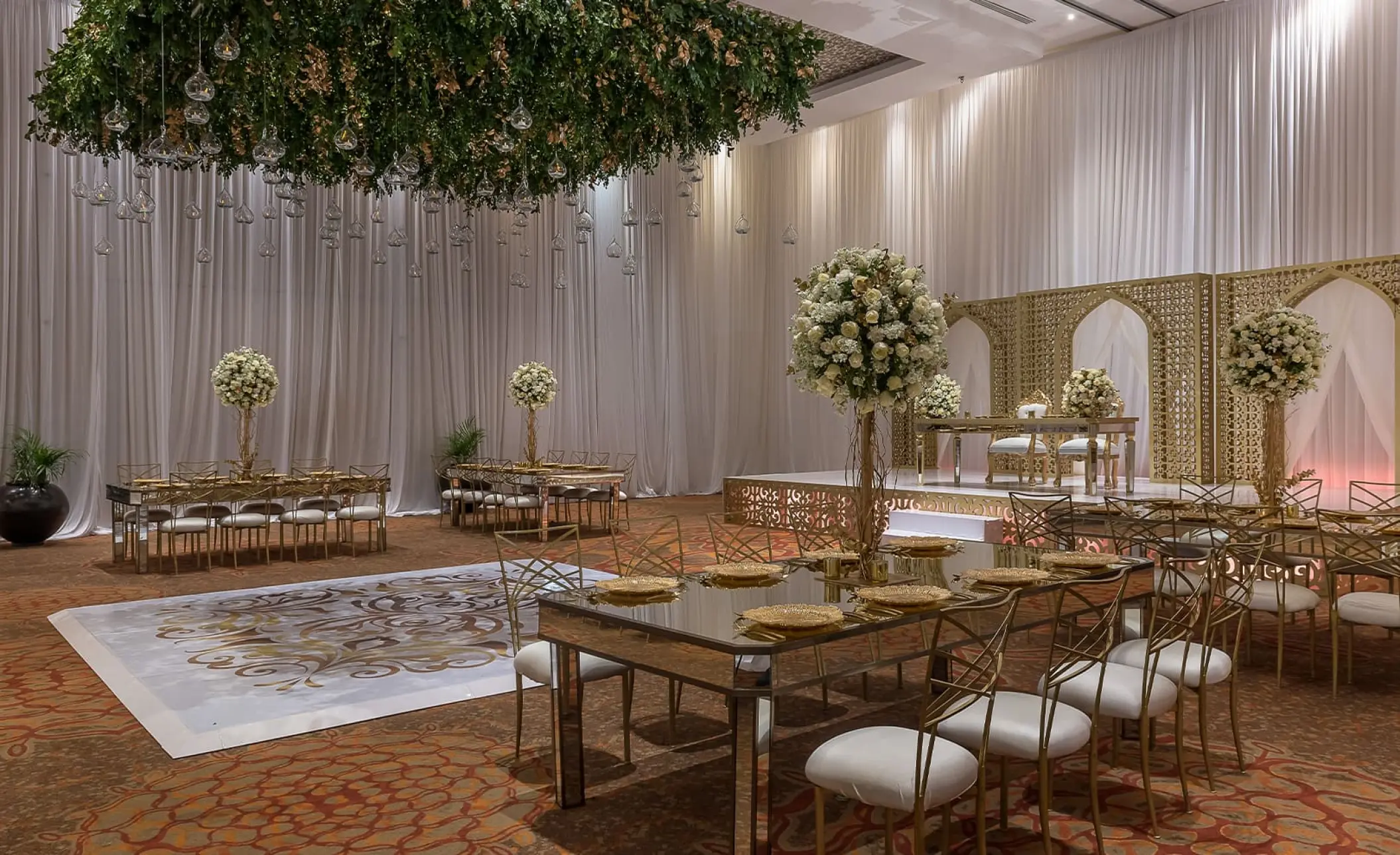 Indoor ballroom wedding reception with gold accents at Moon Palace Cancun