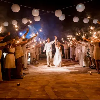 Bride and groom walking through a sparkler exit at Moon Palace Cancun