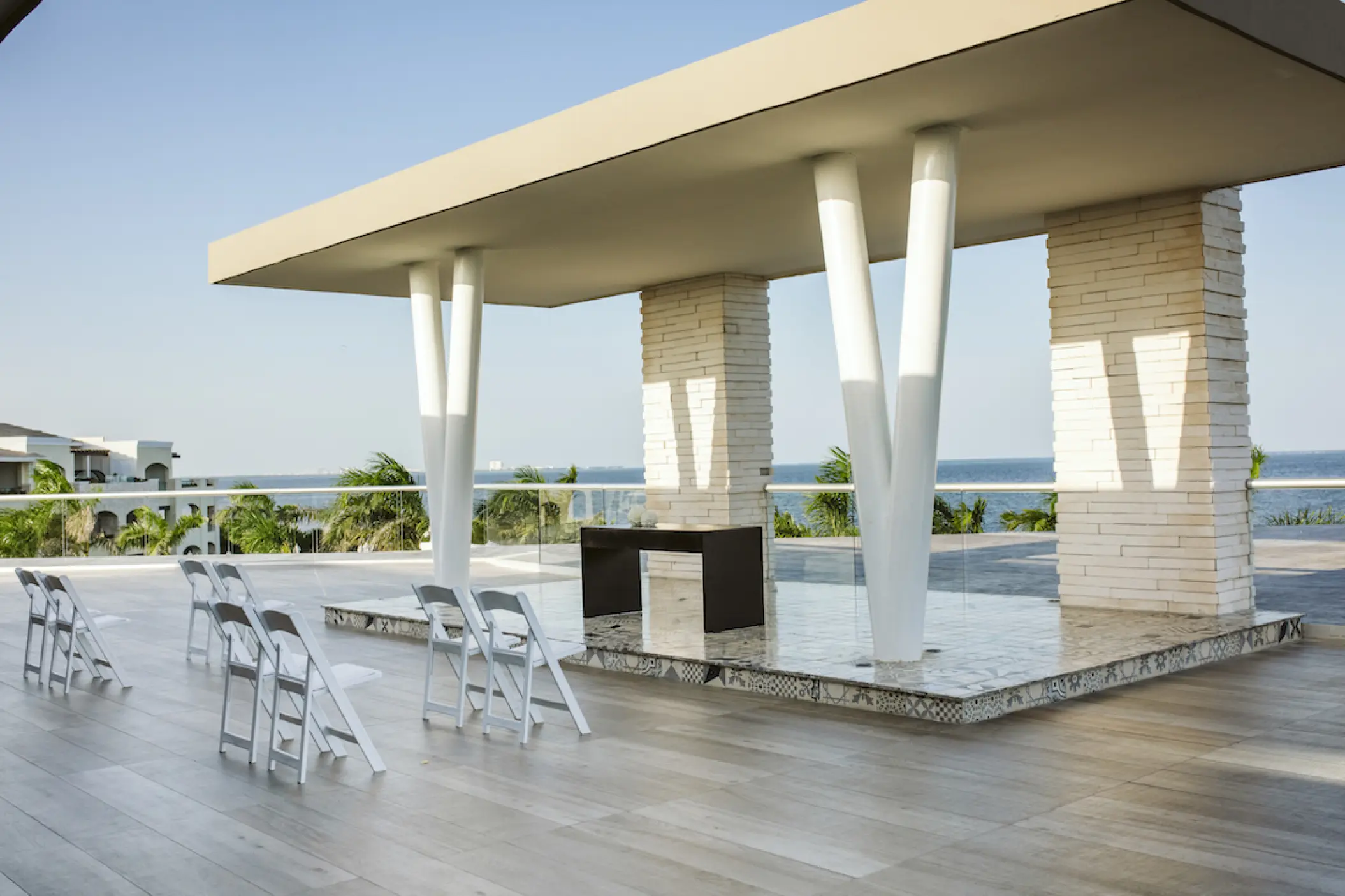 Cusco Terrace wedding ceremony setup with white chairs at Moon Palace Cancun