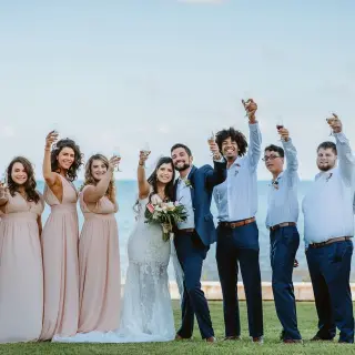 The wedding party raising a champagne toast at Moon Palace Cancun