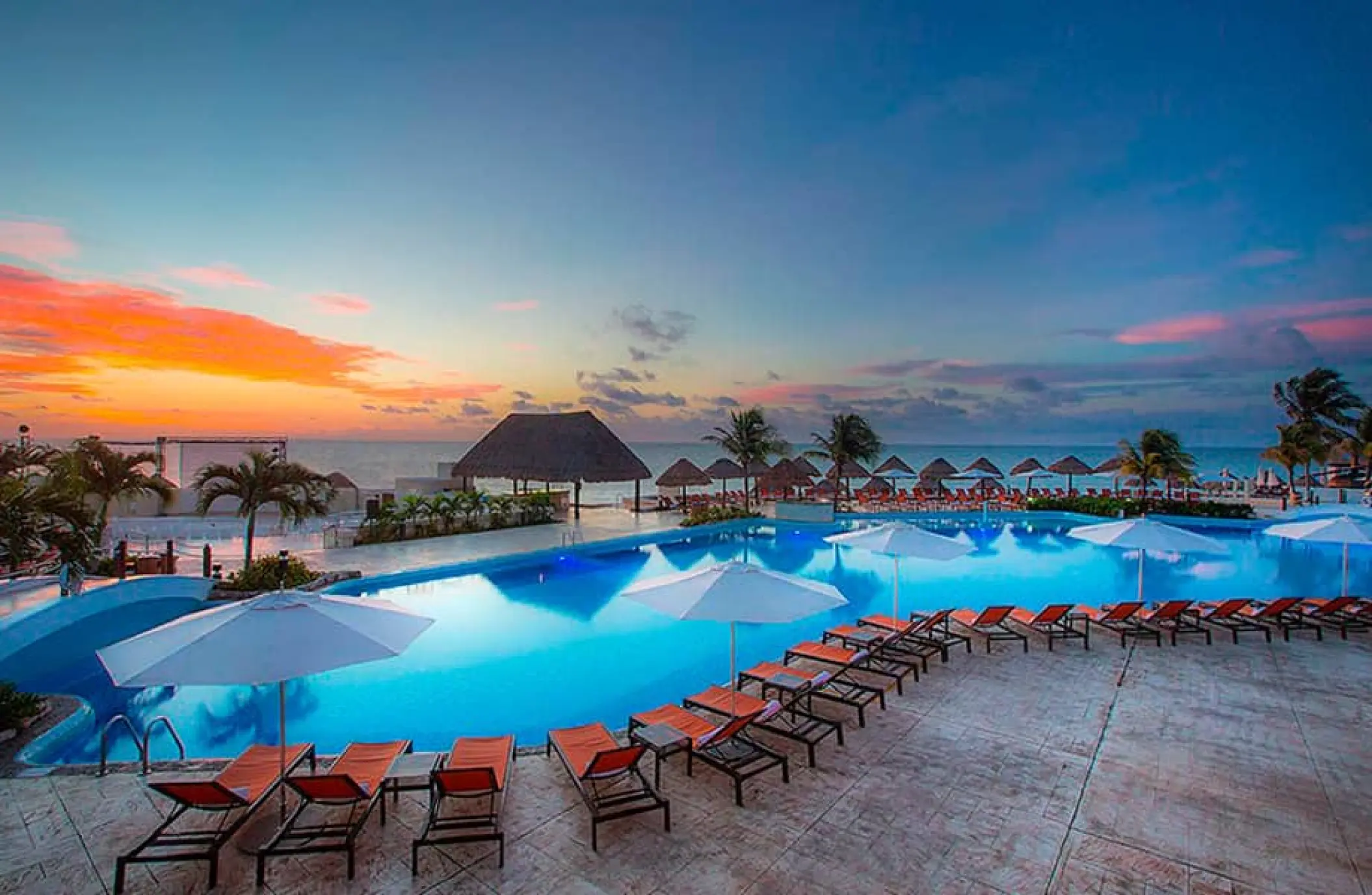 Moon Palace Cancun swimming pool and lounge chairs at sunset, Cancun