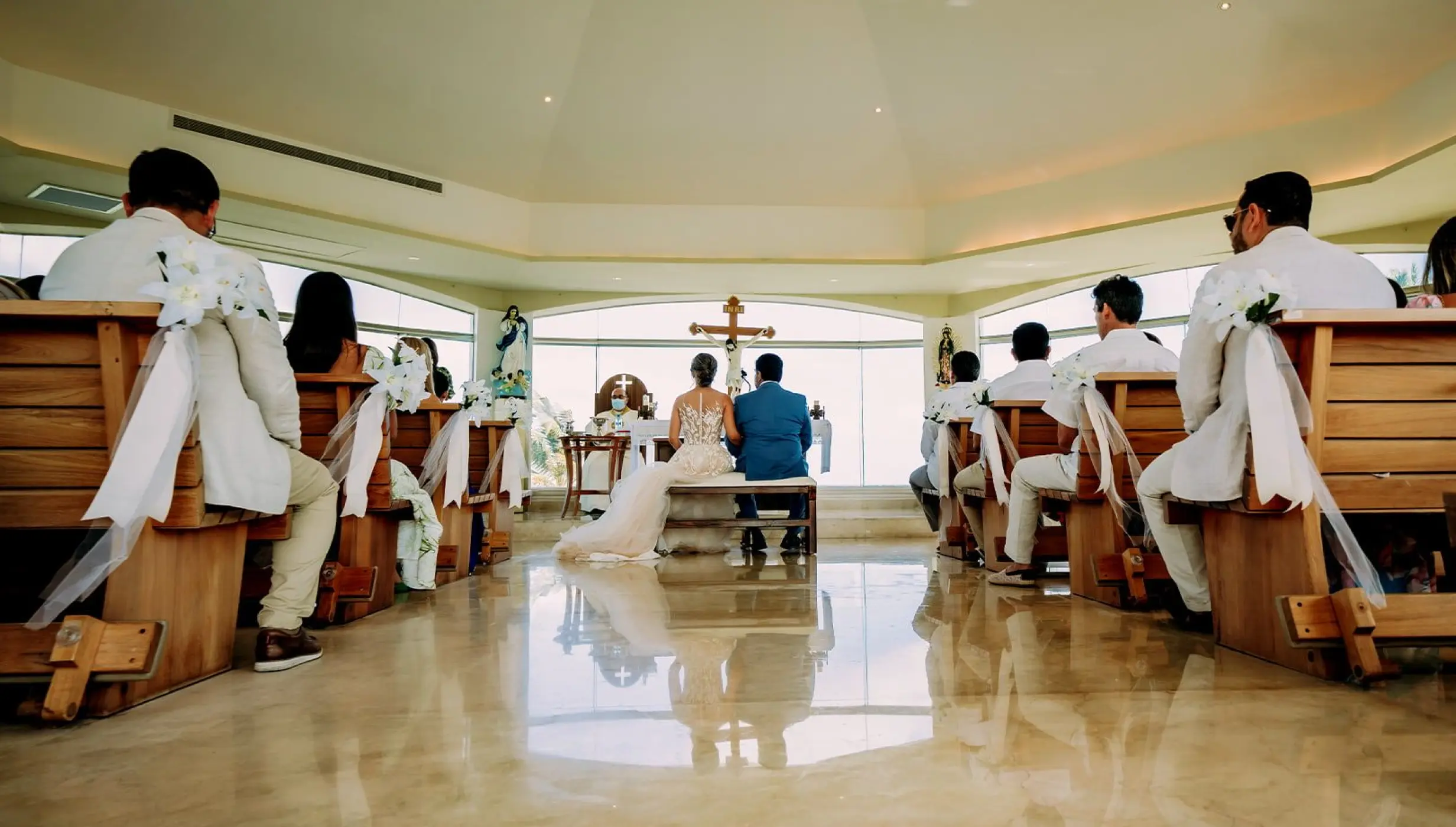Catholic wedding ceremony in the glass-walled chapel at Moon Palace Cancun