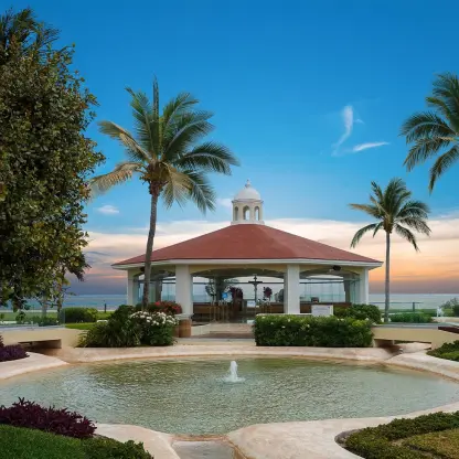 Glass-walled wedding chapel and fountain at Moon Palace Cancun