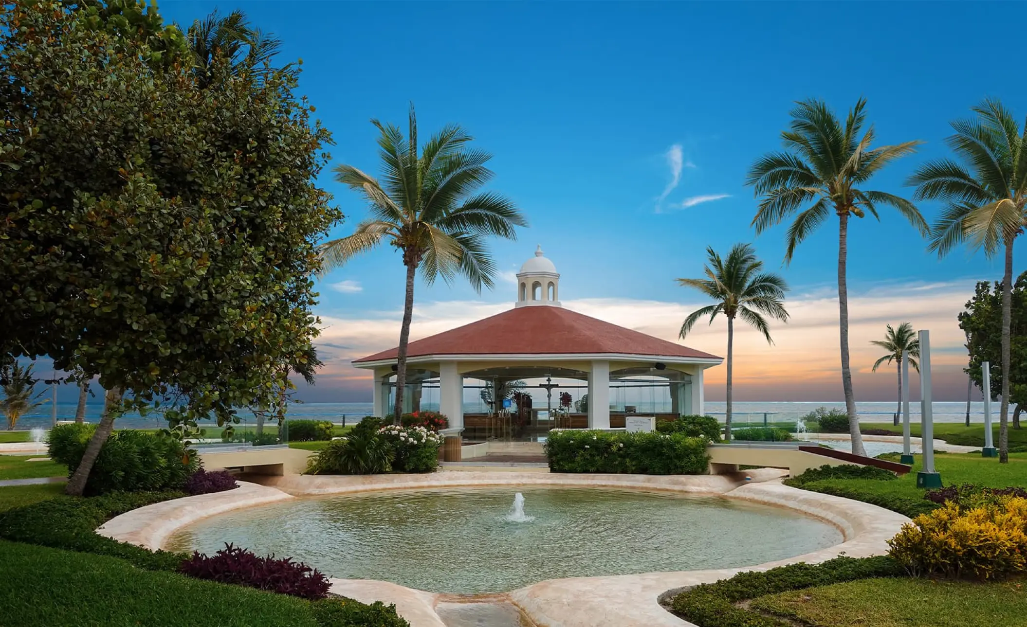 Glass-walled wedding chapel and fountain at Moon Palace Cancun