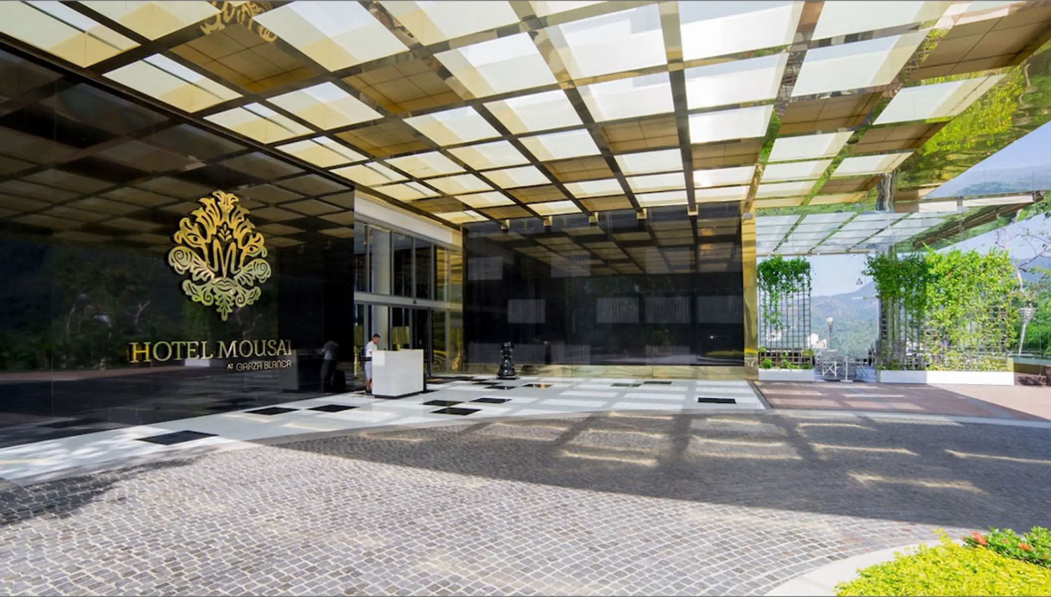 Modern motor lobby entrance with gold latticed ceiling at Hotel Mousai, Puerto Vallarta