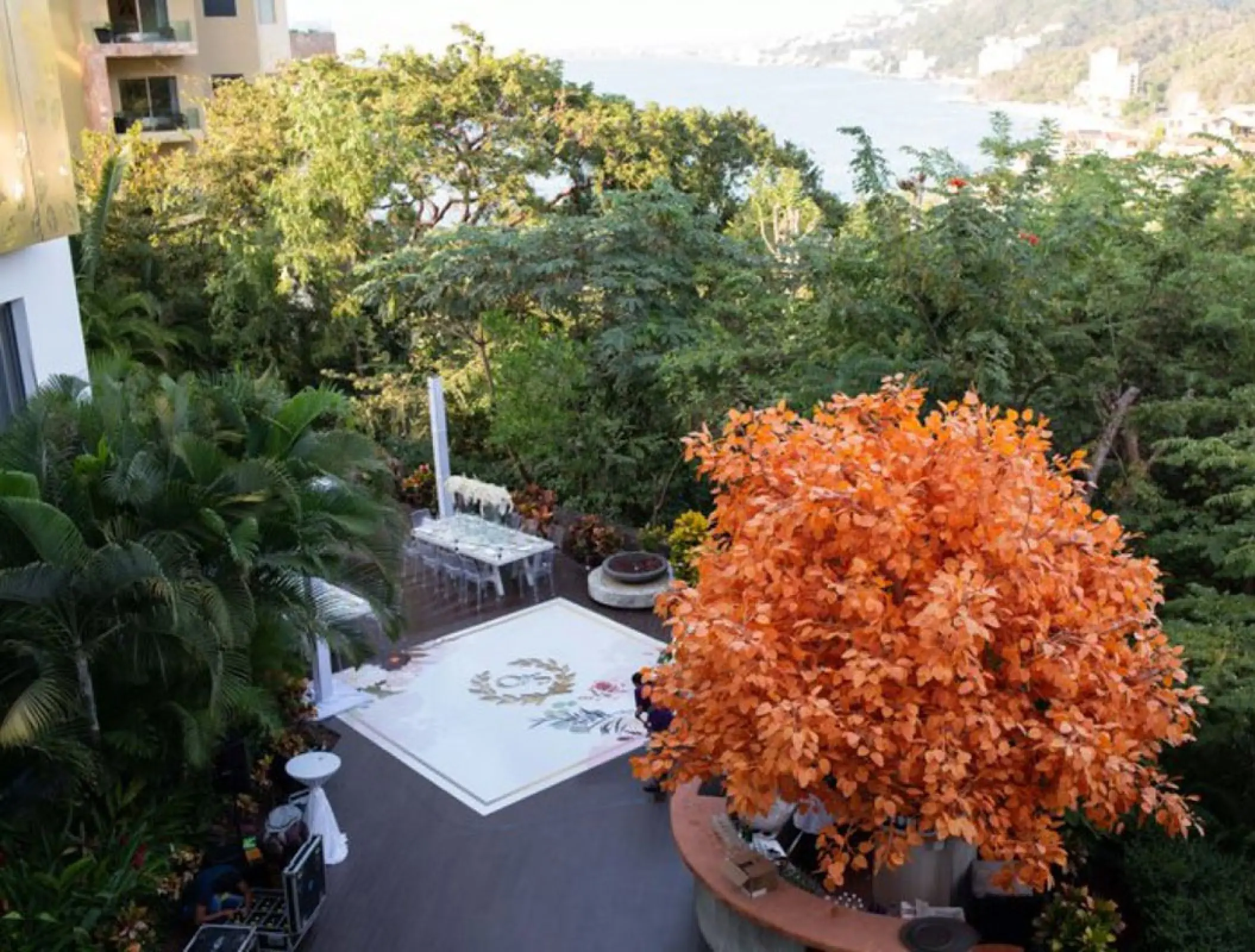 Outdoor terrace wedding reception with dance floor and orange tree at Hotel Mousai, Puerto Vallarta