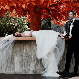 Bride lying on a stone ledge next to a groom at Garza Blanca Puerto Vallarta
