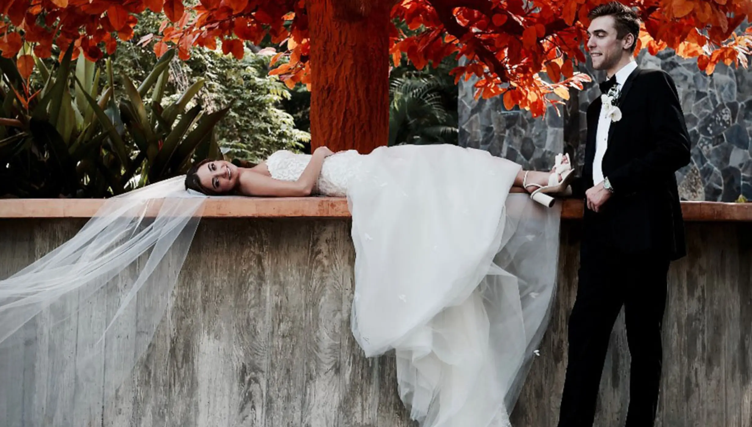 Bride lying on the orange deck under the Orange Tree at Garza Blanca Preserve, Puerto Vallarta