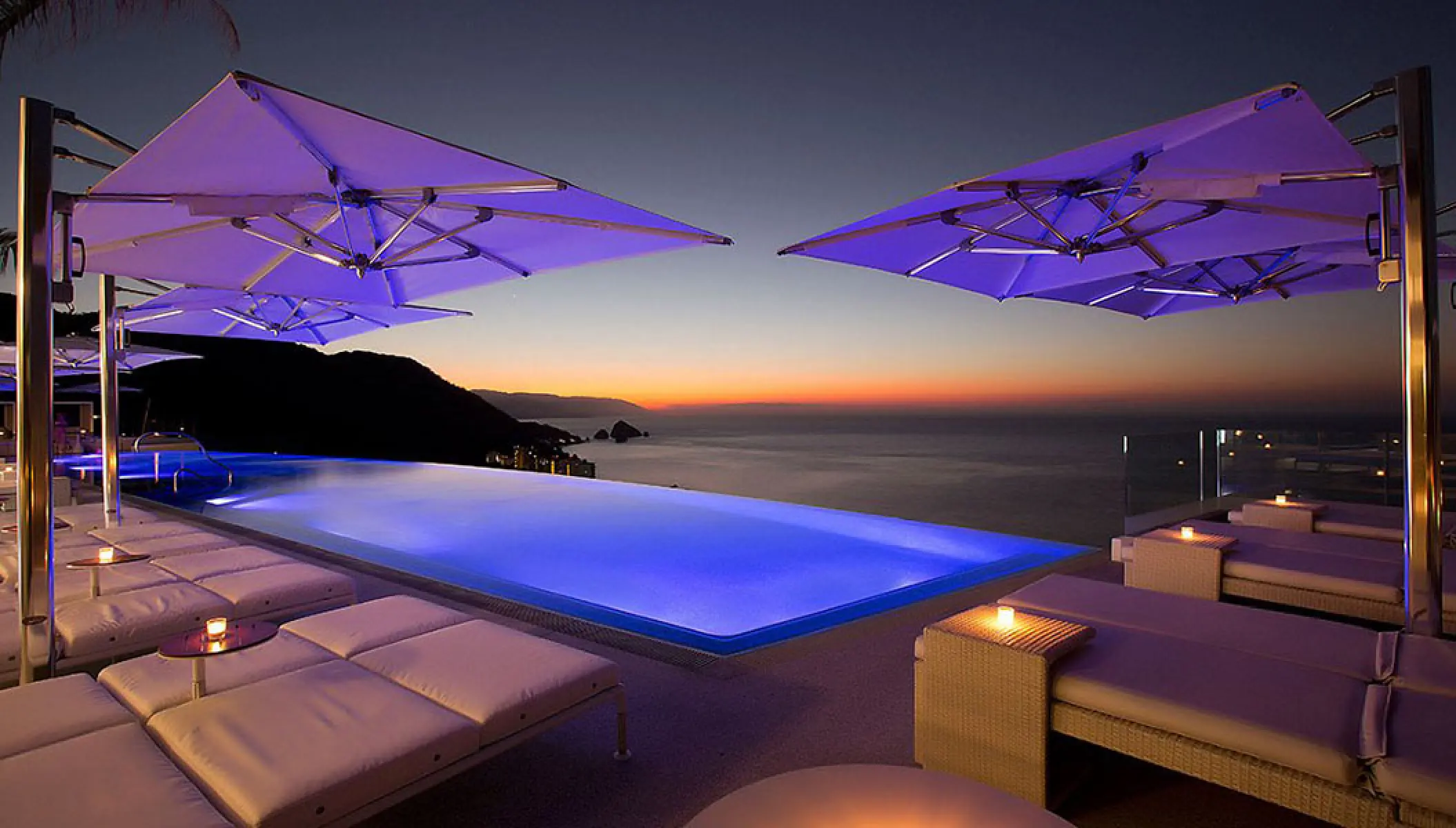 Rooftop infinity pool with purple lighting at Hotel Mousai, Puerto Vallarta