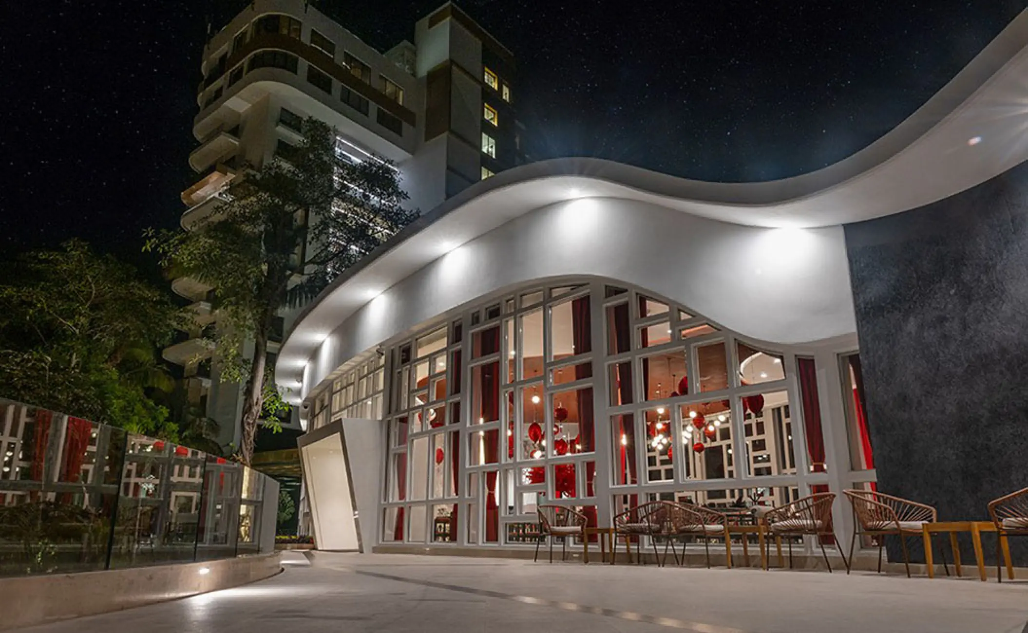 Modern curved exterior of DAO restaurant at night, Hotel Mousai Puerto Vallarta