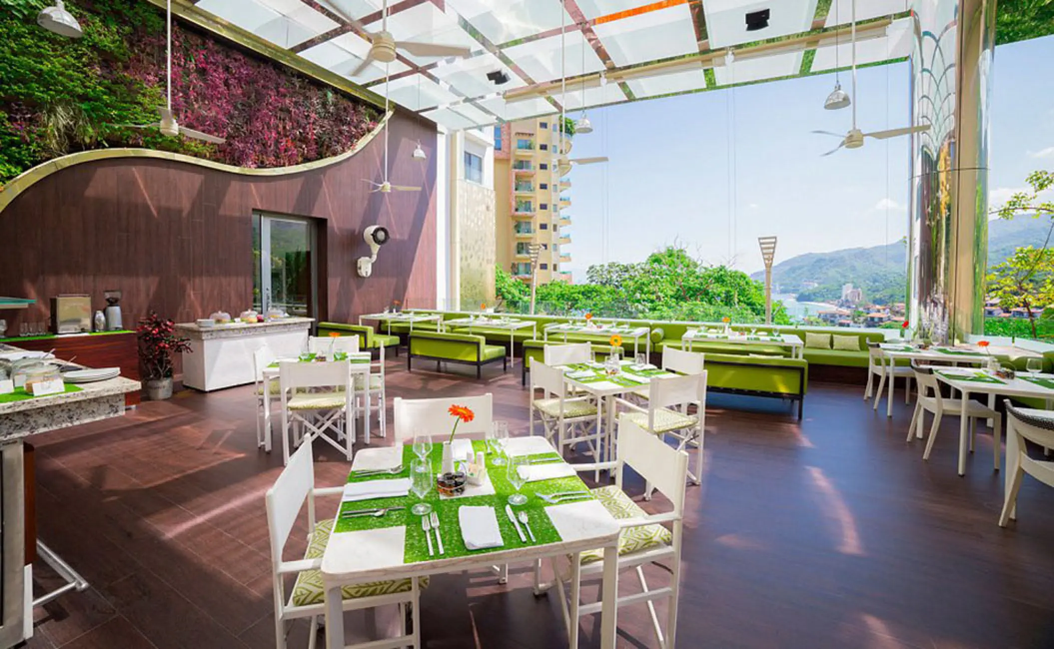 The Terrace restaurant dining area with modern white and green seating at Hotel Mousai Puerto Vallarta