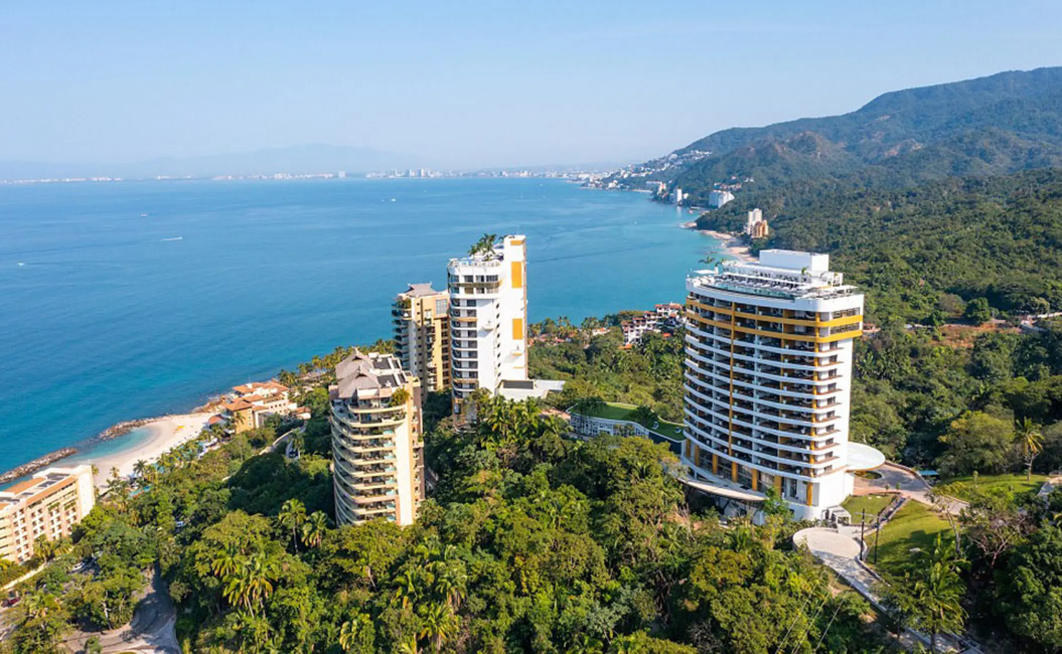 Aerial view of Hotel Mousai towers nestled in lush jungle overlooking the Pacific Ocean, Puerto Vallarta