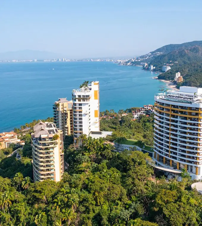 Aerial view of Hotel Mousai towers nestled in lush jungle overlooking the Pacific Ocean, Puerto Vallarta
